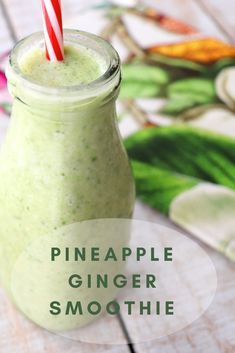 pineapple ginger smoothie in a mason jar with a red and white striped straw