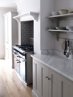 a kitchen with an oven, stove and cabinets in the middle of it is shown