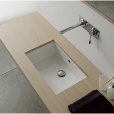 black and white photograph of bathroom sink with soap dispenser