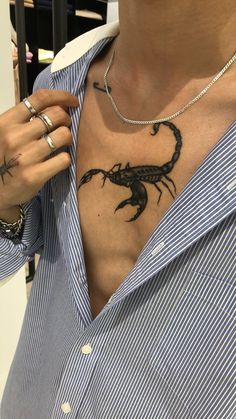 a man with a scorpion tattoo on his chest