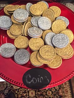 a red bowl filled with gold and silver oreo cookies on top of a rug