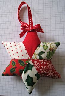 three christmas ornaments are hanging on a white tablecloth with red and green decorations in the shape of stars