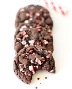 chocolate peppermint cookies with white and red sprinkles on a white surface