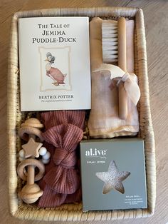 a basket filled with books and toys on top of a wooden table