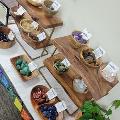 the table is set up with bowls and trays of rocks, stones and plants