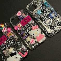 three cell phones with hello kitty designs on them sitting next to each other, all covered in different types of accessories