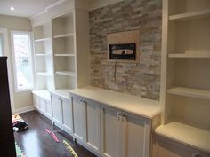 an empty room with built in bookshelves and shelves