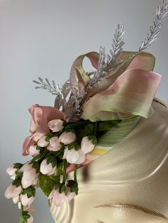 This fancy fascinator hat is a great little headpiece for any occasion that calls for a bit of style. The base is a covered in reycyled silk. It's topped with vintage pink dangling rosebuds, ribbon loops and flower, crystal leaves and opalescent shiny vintage leaves. It sits at a dramatic angle on the head for maximum style. The small scale of this fascinator makes it easy to wear for events or even to dinner. Completely hand sewn for a uniquely one-of-a-kind hat. Mounted on a narrow headband to Whimsical Structured Crown Headpiece For Party, Kentucky Derby Hat-style Headband Gift, Party Fascinator With Ribbon, Elegant Spring Ribbon Fascinator, Elegant Headband For Royal Ascot Gift, Pink Hair Accessories For Spring Formal Events, Pink Fascinator For Kentucky Derby With Structured Crown, Pink Structured Crown Fascinator For Kentucky Derby, Pink Kentucky Derby Fascinator With Structured Crown