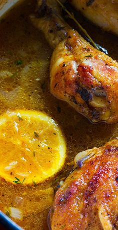 chicken thighs with lemons and herbs in a pan