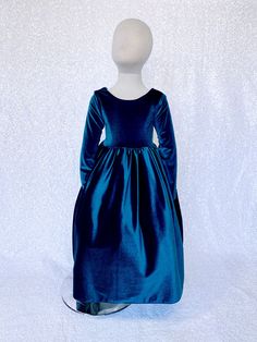 a mannequin dressed in a blue dress on a white background with no head