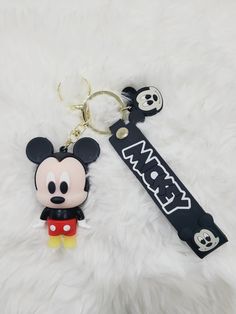 a mickey mouse keychain with a skull on it