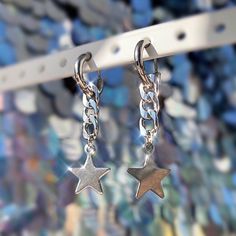 ♡ These unisex hoop earrings are made from pure stainless steel and are lightweight, safe for sleeping, and safe for the shower. ♡ Choose from 1 single earring or a pair of 2! ♡ ♡ Featuring curb chain and shiny star shaped charms dangling from 10 mm huggie hoops! ♡ ♡ These hoop earrings are a fun, timeless staple for any jewelry collection! Minimal yet edgy and industrial, these are so versatile & can be worn with variety of styles and aesthetics. Super versatile, great for casual everyday w Silver Star-shaped Hoop Earrings, Trendy Metal Hoop Earrings With Star Charm, Hypoallergenic Star-shaped Metal Hoop Earrings, Rave Accessories, Rave Festival, Ethereal Art, Single Earring, Everyday Jewelry, Curb Chain