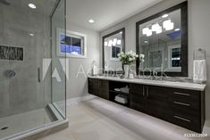 a large bathroom with two sinks and a walk in shower