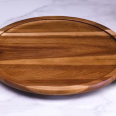 a wooden cutting board sitting on top of a white counter