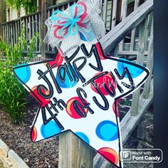 a star shaped sign that says, happy 4th of july on the side of a wooden fence