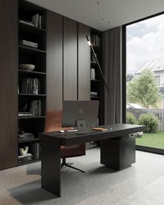 a desk with a laptop on it in front of a bookcase filled with books