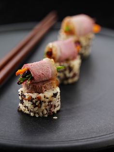 some kind of sushi with chopsticks on the side