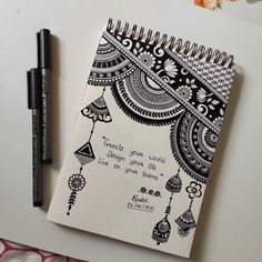 a notebook with a quote on it next to a pen