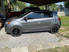 a silver car parked in front of a house