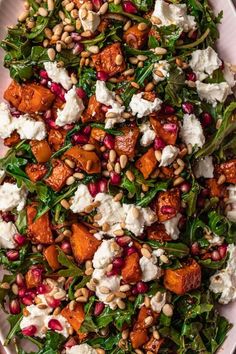 a white plate topped with greens and sweet potato salad