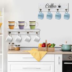 there are cups and mugs hanging on the wall above the kitchen counter, along with other items