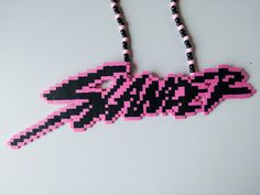 a pink and black beaded necklace with the word swag on it's side