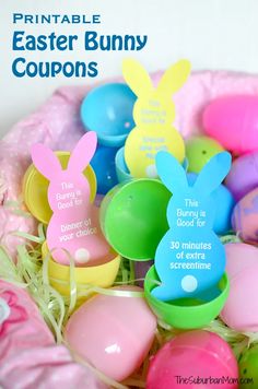 an easter basket filled with colorful plastic eggs and bunny ears on top of each other