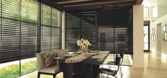 a dining room with wooden blinds and chairs