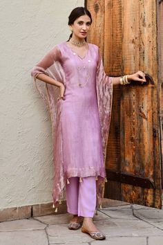 Lilac shimmer finish kaftan. Paired with cotton pant.
Components: 2
Pattern: Plain
Neckline: V Neck
Sleeve Type: Batwing Sleeves
Fabric: Tissue, Cotton
Color: Purple
Other Details: 
Kaftan:
Tasselled hem
Occasion: Sangeet - Aza Fashions Elegant Cotton Silk Pant Set For Festive Occasions, Elegant Cotton Silk Pant Set For Festive Season, Elegant Festive Cotton Silk Pant Set, Eid Pant Set With Sheer Dupatta And Straight Kurta, Elegant Chanderi Pant Set For Eid, Elegant Kaftan With Sheer Dupatta For Diwali, Elegant Diwali Kaftan With Sheer Dupatta, Unstitched Pant Set With Sheer Dupatta For Diwali, Bollywood Style Pant Set With Sheer Dupatta For Eid