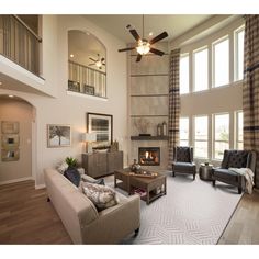 a living room filled with furniture and a fire place in the middle of a room