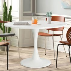 a white table with three blue chairs around it