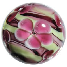 a glass bead with pink and white flowers on it is featured for the holiday joy is happening on ebay