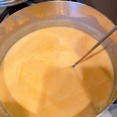 a large metal bowl filled with liquid on top of a stove