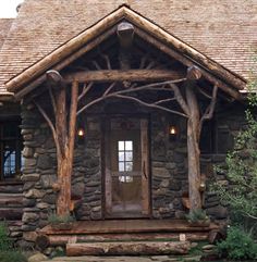 an old log cabin with stone and wood trimming on the front door is shown