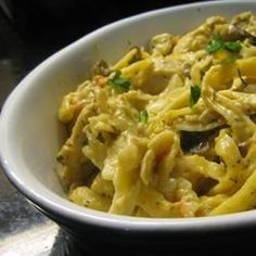 a white bowl filled with pasta and vegetables