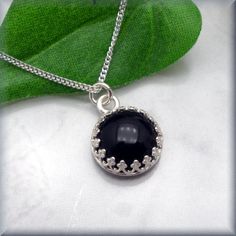 A lovely 10mm black onyx cabochon is set off to perfection in a sterling silver setting. The gallery wire bezel setting plays on the stone's classic beauty and creates a beautiful eye-catching necklace. Easily your go-to everyday necklace. Setting and curb chain are sterling silver. My black onyx earrings can be found here: https://www.etsy.com/listing/162000490/black-onyx-earrings-sterling-silver Jewelry is packaged in a cotton lined box for gift-giving. See more Bonny Jewelry at http://bonnyje Dinosaur Pendant, Mirror Jewelry, Cabochon Necklace, Black Onyx Earrings, Silver Ring Designs, Bezel Necklace, Black Onyx Necklace, Jewelry Minimalist, Onyx Jewelry