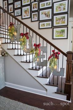 christmas decorations are hanging on the banister