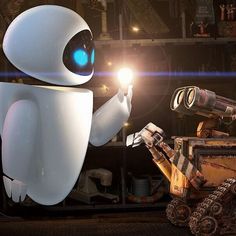 a robot holding a flashlight next to a robotic