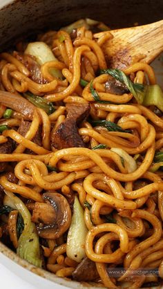 stir fried noodles with mushrooms and vegetables in a pot