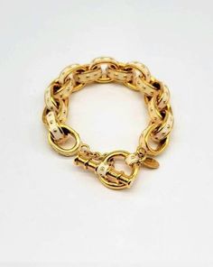 "Enamel Link Bracelet, Gold Rolo Bracelet, Large Link Bracelet, Rolo Link Bracelet, Rolo Chain Bracelet, Kenneth Jay Lane Bracelet, KJL EXCELLENT VINTAGE CONDITION Measurements: 7\" from end to beginning of toggle closure. 7.75\" including the full toggle closure. Metal Type: Gold Tone Findings: Toggle Closure, easy on easy off! Finish: Polished Looking for a Rolo chain link bracelet that doesn't look like everyone else's? Kenneth Jay Lane is masterful in his ability to take classic styles and make them special, and this piece is no exception! The style of the bracelet is done in a traditional way with shining yellow gold tone oval links interlocking one another. What takes it to the next level is the size of the links and the detailing on the sides. The volume on the links have been pumpe Tarpon Springs, Toggle Bracelet, Rolo Chain, Kenneth Jay Lane, Bracelet Gold, Ivory Color, Polished Look, Chain Link Bracelet, Gold Beads