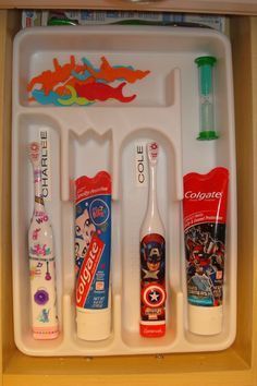 toothbrushes, toothpaste and other hygiene products are organized in a tray