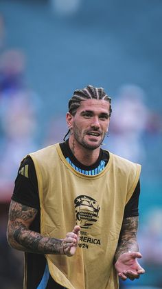 a man with dreadlocks standing in front of a crowd