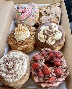 a box filled with lots of different flavored donuts