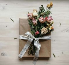 a present wrapped in brown paper with flowers on it