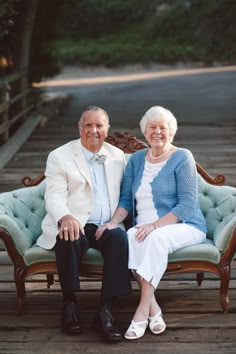 an older man and woman sitting on a bench