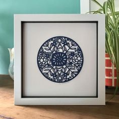 a blue and white plate sitting on top of a table next to a potted plant