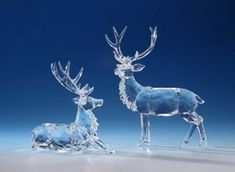 two crystal deer figurines sitting next to each other