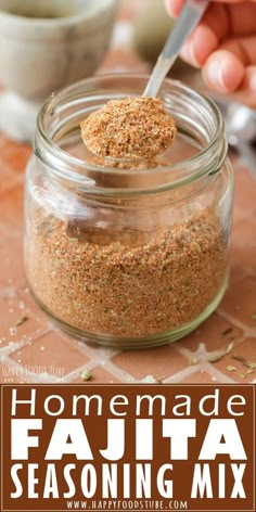 homemade fajita seasoning mix in a glass jar with a spoon sticking out of it