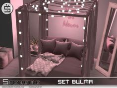 a bed with pink sheets and pillows in a room that has lights strung from the ceiling