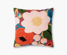 an orange and pink pillow with flowers on it